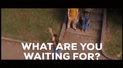 Woman On Sidewalk Saying What Are You Waiting For GIF