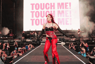 Woman On Stage In Front Of Touch Me Screen GIF