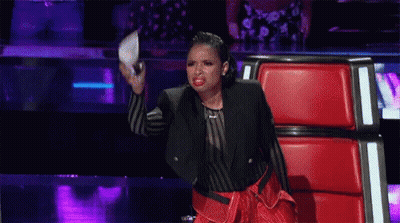 Woman On Stage In Red Chair Holding Microphone GIF