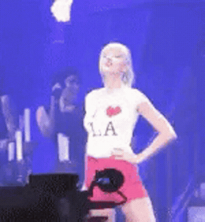 Woman On Stage With Hands On Hips Wearing LA Shirt GIF