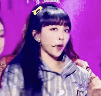 Woman On Stage With Yellow Hair Clip GIF