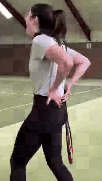 Woman On Tennis Court Holding Tennis Racquet GIF
