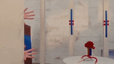 Woman Peeking Behind Bathroom Wall GIF