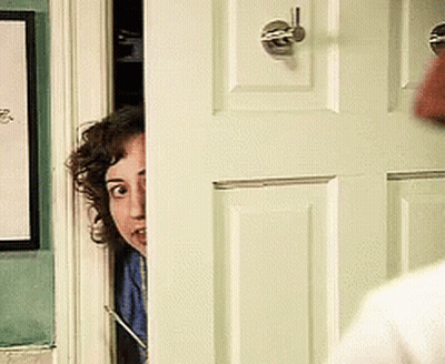 Woman Peeking From Behind Door With Picture GIF