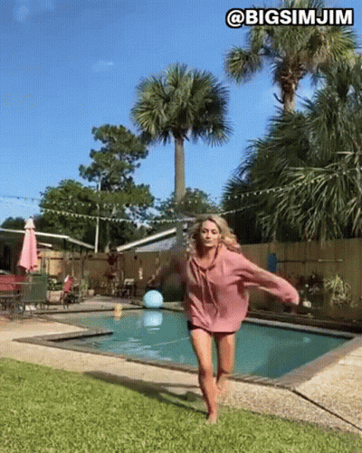 Woman Peeking From Behind Wall GIF