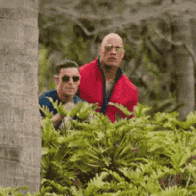 Woman Peeking Out From Behind Tree GIF