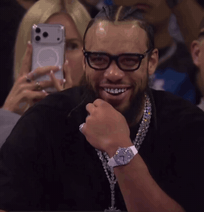 Woman Photographing Man With Glasses And Cross Necklace GIF