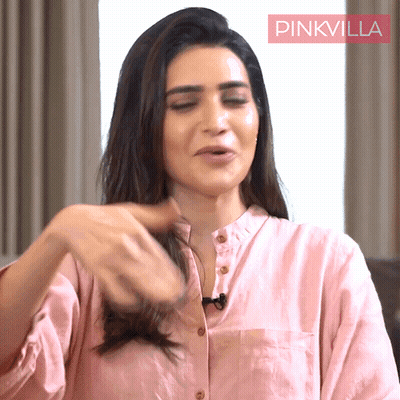Woman Pink Shirt Playing With Hair Pink Villa Sign GIF
