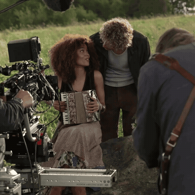 Woman Playing Accordion In Front Of North America Camera GIF