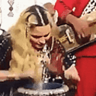 Woman Playing Drums With Man Playing Guitar