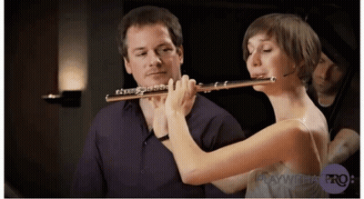 Woman Playing Flute In Front Of Man Playing Cello GIF