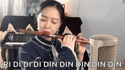 Woman Playing Flute In Front Of Piano Ri Di Di Din Din Din Din Din Din GIF
