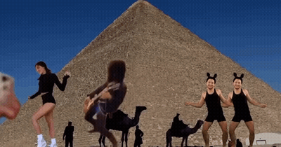 Woman Playing Guitar In Front Of Pyramid GIF