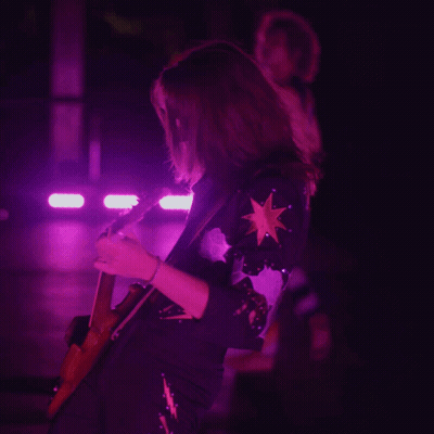 Woman Playing Guitar In Purple Light GIF