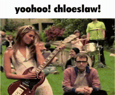 Woman Playing Guitar Man Watching In Grass GIF