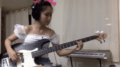 Woman Playing Guitar Near Keyboard GIF