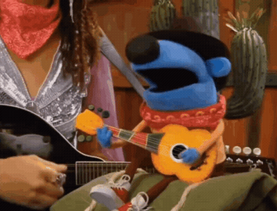 Woman Playing Guitar Next To Puppet Playing Guitar GIF