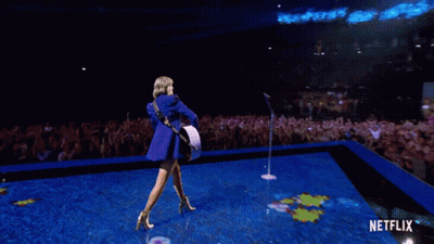 Woman Playing Guitar On Stage With Netflix GIF