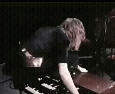 Woman Playing Piano In Dark Room GIF