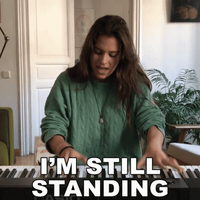 Woman Playing Piano Saying I'm Still Standing GIF