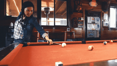 Woman Playing Pool In Bar GIF