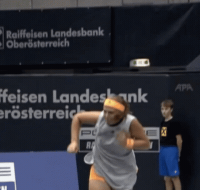 Woman Playing Tennis In Front Of Raiffeisen Landesbank Sign GIF