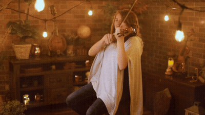 Woman Playing Violin With String Lights GIF