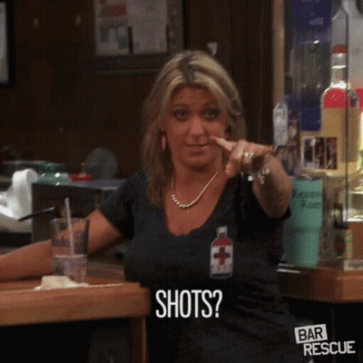 Woman Pointing At Camera Wearing Shots Shirt GIF