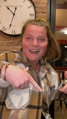 Woman Pointing At Clock Saying Grand Hotel GIF