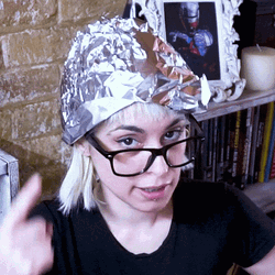 Woman Pointing Head With Tin Hat GIF