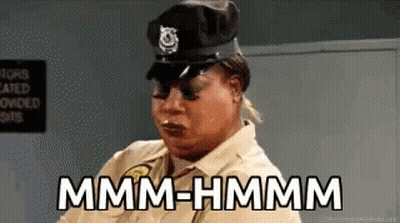 Woman Police Uniform Saying Mmmm Hmmm GIF