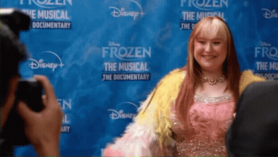 Woman Posing In Front Of Frozen Poster GIF