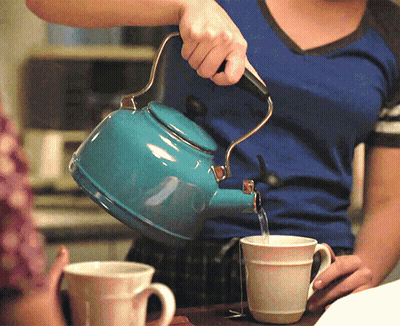 Woman Pouring Water From Blue Tea Kettle GIF