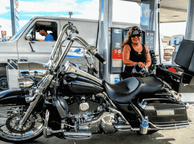 Woman Pumping Gas Into Harley Davidson Motorcycle GIF