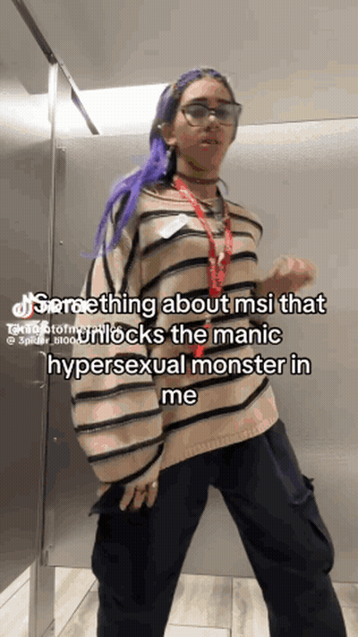 Woman Purple Hair Glasses Bathroom MSI Caption GIF