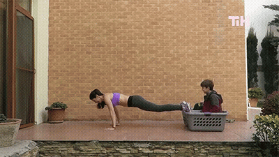 Woman Push Ups Near Laundry Basket GIF