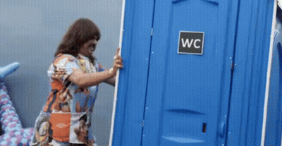 Woman Pushing Blue Portable Toilet Door Open GIF
