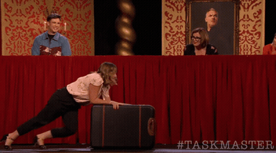 Woman Pushing Suitcase With #Taskmaster GIF
