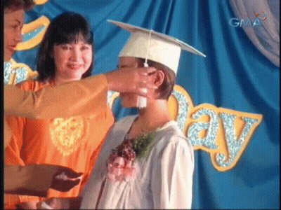 Woman Putting Graduation Cap GIF