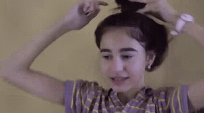 Woman Putting Hair In A Bun While Wearing Watch GIF