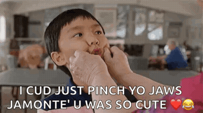 Woman Putting Hand On Boy's Face Making Funny Face GIF
