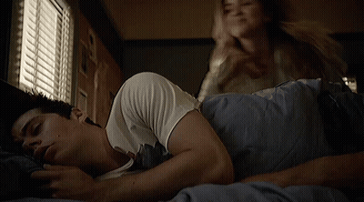 Woman Putting Hand On Sleeping Man's Chest In Bed GIF