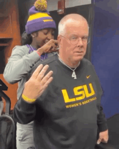 Woman Putting Necklace On Man In LSU Basketball Sweatshirt GIF