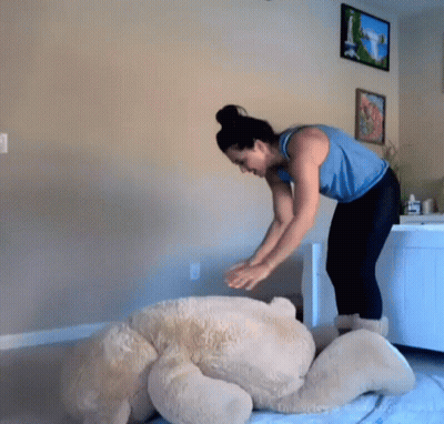 Woman Putting Teddy Bear on Floor