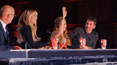 Woman Raising Hand At Table GIF