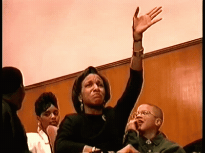 Woman Raising Hand In Crowd GIF