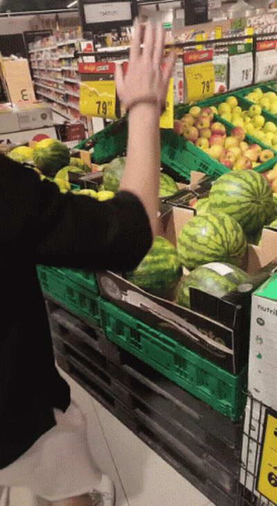Woman Reaching For Box Of Watermelons GIF