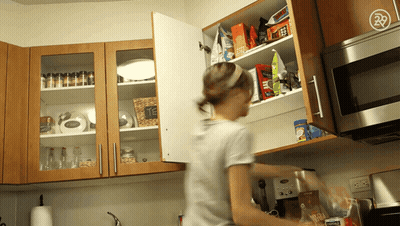 Woman Reaching For Nescafe Coffee In Cupboard GIF