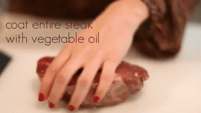 Woman Reaching For Steak Coat Entire Steak With Vegetable Oil GIF
