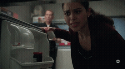 Woman Reaching Into Refrigerator With Pills GIF
